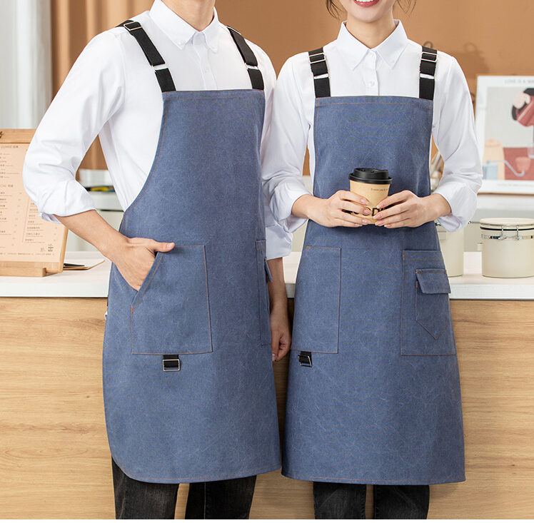 Washed denim cross back apron 8102 detail image with adjustable straps and pocket design